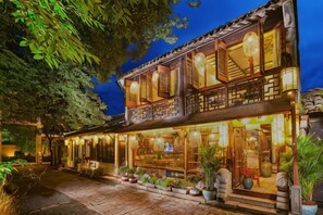 A traditional building with a wooden facade, large windows, and a balcony. - Zhouzhuang Latte Play Stone Mulan Hotel (Kunshan)