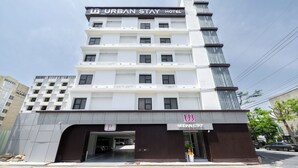 A multi-story hotel with a modern design, featuring a prominent "URBAN STAY HOTEL" sign at the top. - Hotel Urbanstay (Jeonju)