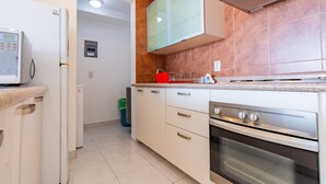 A modern kitchen with white cabinets, a stainless steel oven, and a microwave. - City Views Santa Fe I Lovely 1 BR Apartment Within Santa Fe (Mexico City)