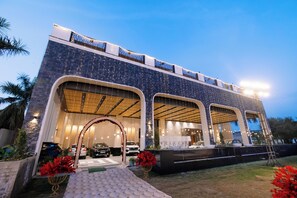 A modern building with large arched entrances, a 'WELCOME' sign, and a well-lit exterior. - Pride Premier Alwar, Sariska  (Alwar)