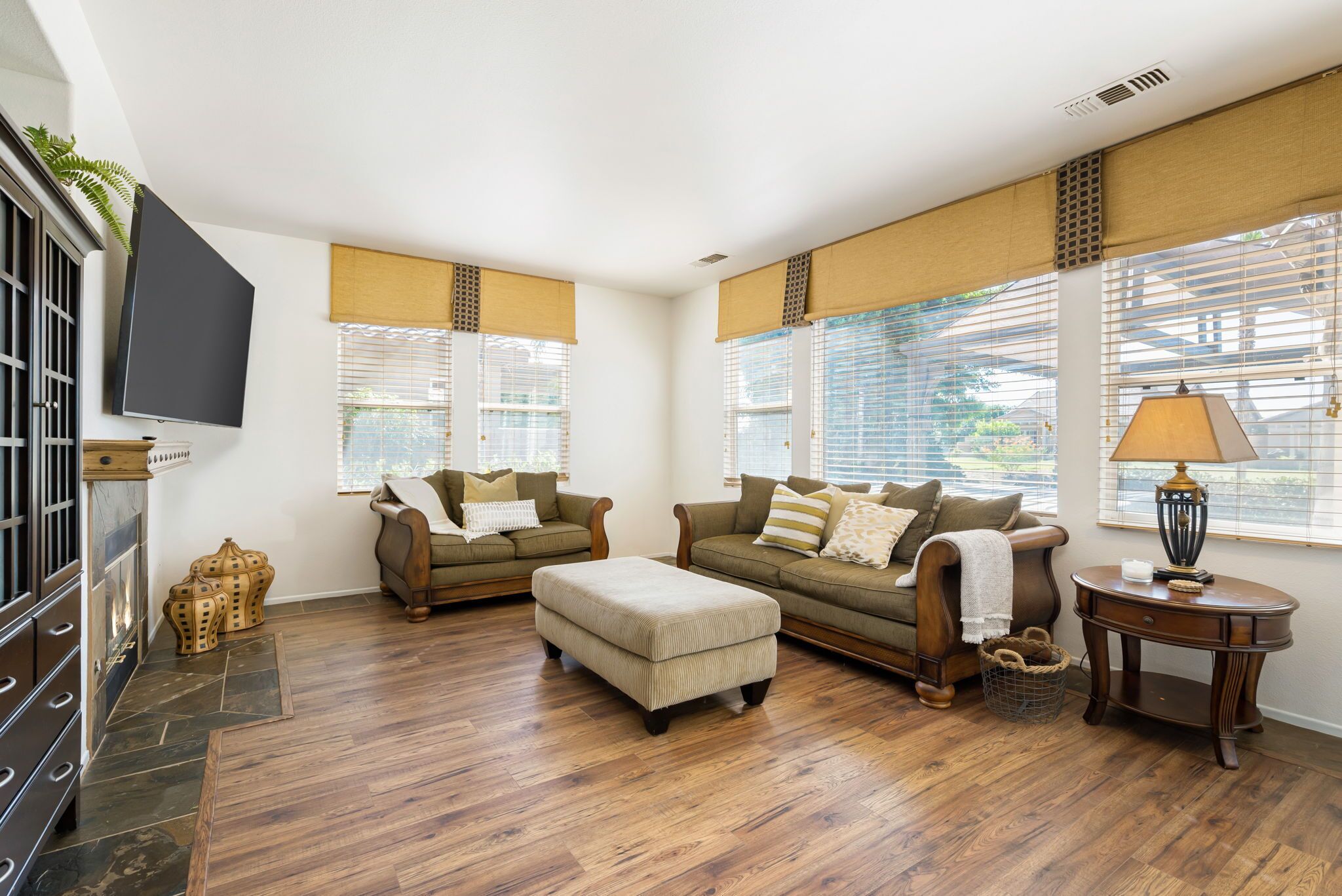 A living room with two sofas, a television, and a lamp.
