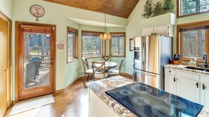 A kitchen with a large island, wooden ceiling, and a dining area with a table and chairs. - Golf, Hike, Explore! Family-Friendly Pinetop Haven (Pinetop Country Club)
