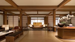 A traditional Japanese-style room with tatami flooring, low wooden beams, sliding shoji doors, and a central tatami mat bed. - Capella Kyoto (Kyoto)