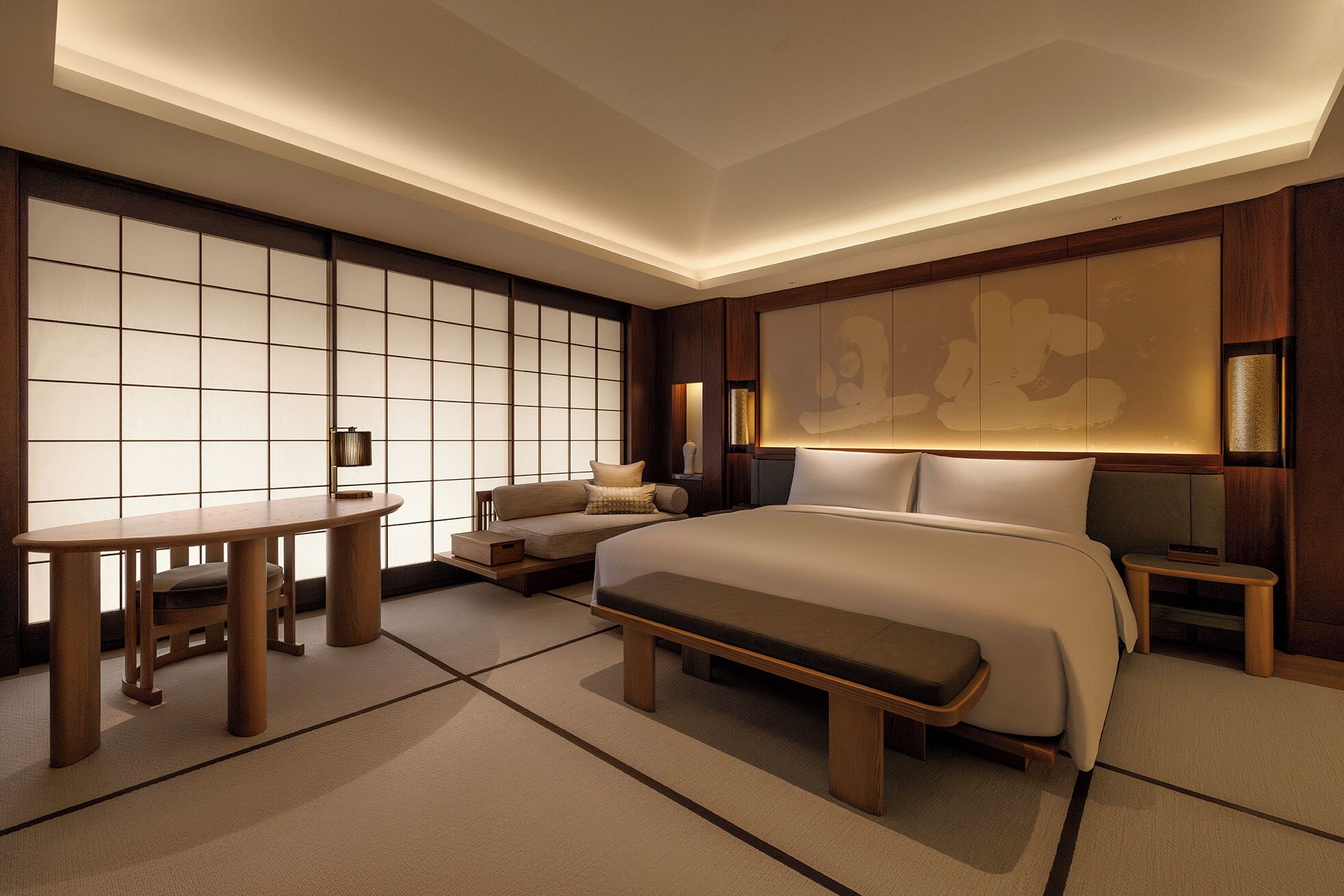 A modern hotel room with a large bed, a desk, a chair, and a sofa.