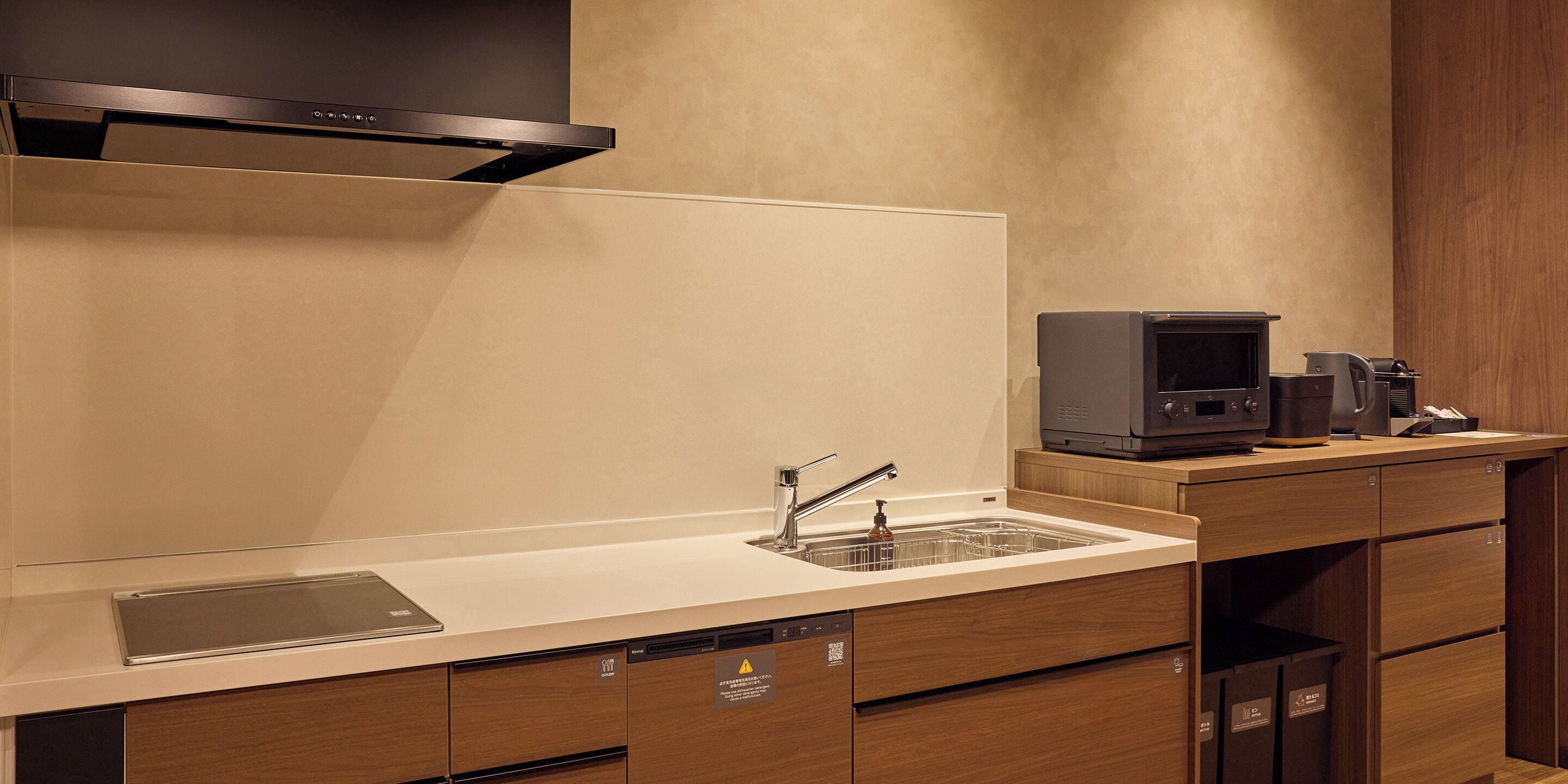 A modern kitchen with a built-in dishwasher, a microwave, and a coffee maker.