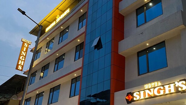 A multi-story hotel building with a prominent sign reading "HOTEL SINGH'S". - Hotel Singh's Vashi Navi Mumbai (Navi Mumbai)