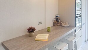 A kitchen counter with a potted plant, a book, and a mug. - Stunning private villa for 5 guests with A/C, TV and balcony (Villasimius)