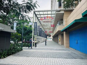 A corridor with a glass ceiling, signs for 'AVINASHONE' and 'AVINASHONE group', and a blue door on the right. - The Vilton (Raipur)
