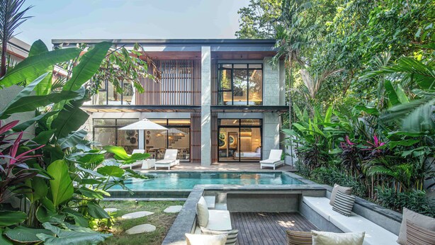 A modern two-story house with a swimming pool, outdoor seating area, and lush greenery. - Designer 5br Villa 400m to Caf del Mar (Seminyak)