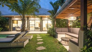A modern house with a pool, outdoor seating, and a well-maintained garden. - Elegant 3BR Retreat Stylish Modern Villa Seminyak (Seminyak)