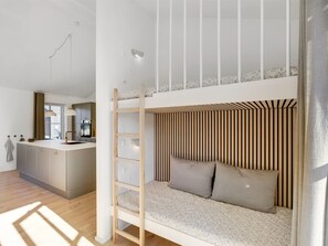 A bunk bed with a ladder, a kitchenette, and a window with curtains. - "Eida" - 500m from the sea by Interhome (Løkken)