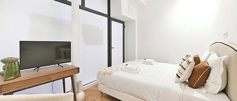 Desk, iron/ironing board, bed sheets