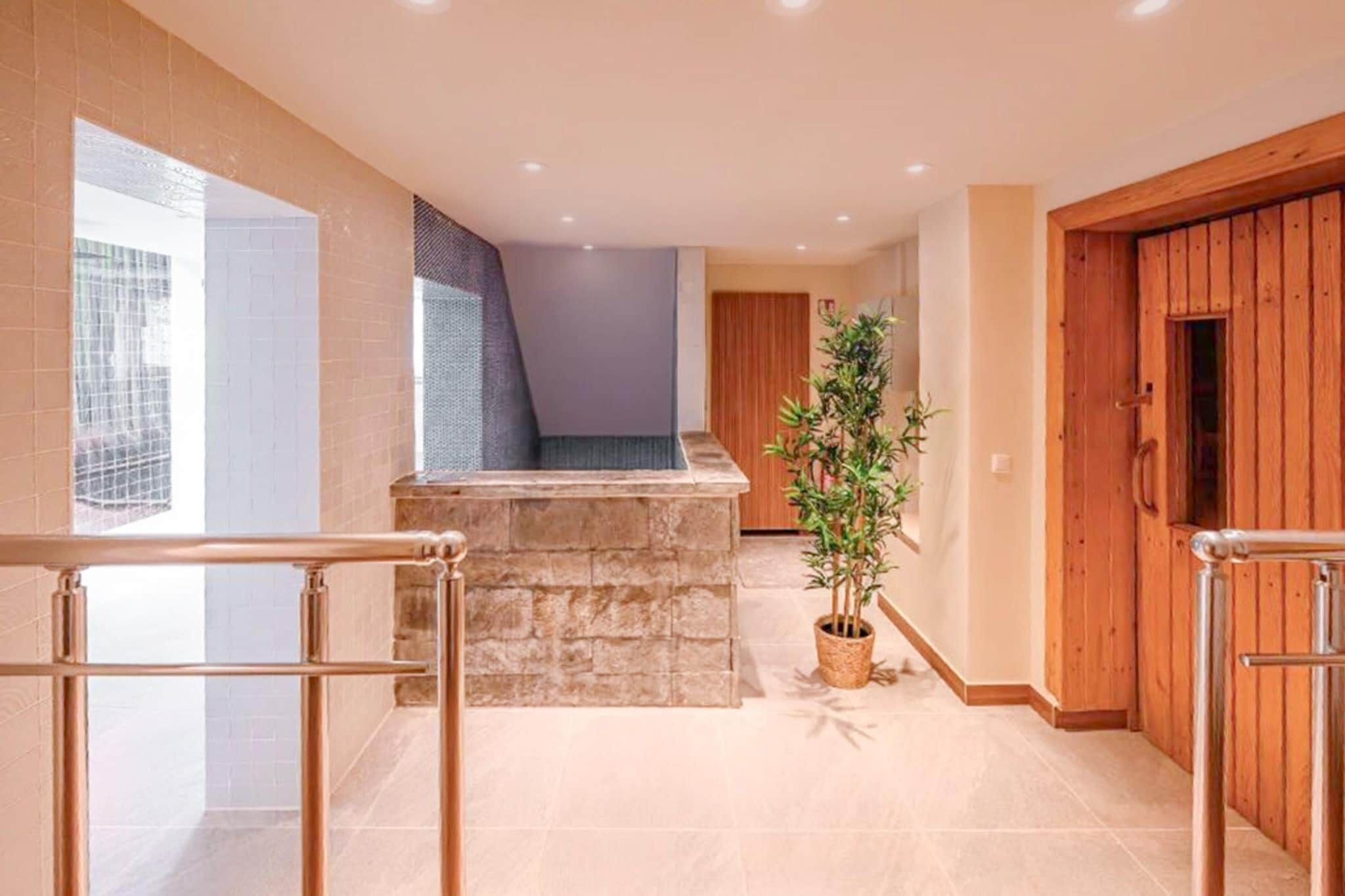 A modern interior with a stone bench, a potted plant, and wooden doors.