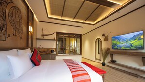 A modern hotel room with a large bed, a TV, and a view of a mountainous landscape. - ZAO Hotel Firework & Sea View (Phu Quoc)