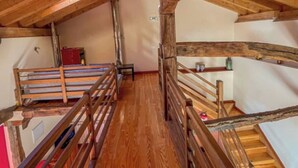 A wooden staircase with a wooden railing leading to a landing. - Casa Berrobiaenea  (Lana)