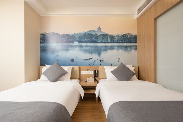 A hotel room with two beds, a nightstand with a phone, and a wall mural of a lake with a pagoda. - Zhishang Hotel Hangzhou West Lake Zheyi (Hangzhou)