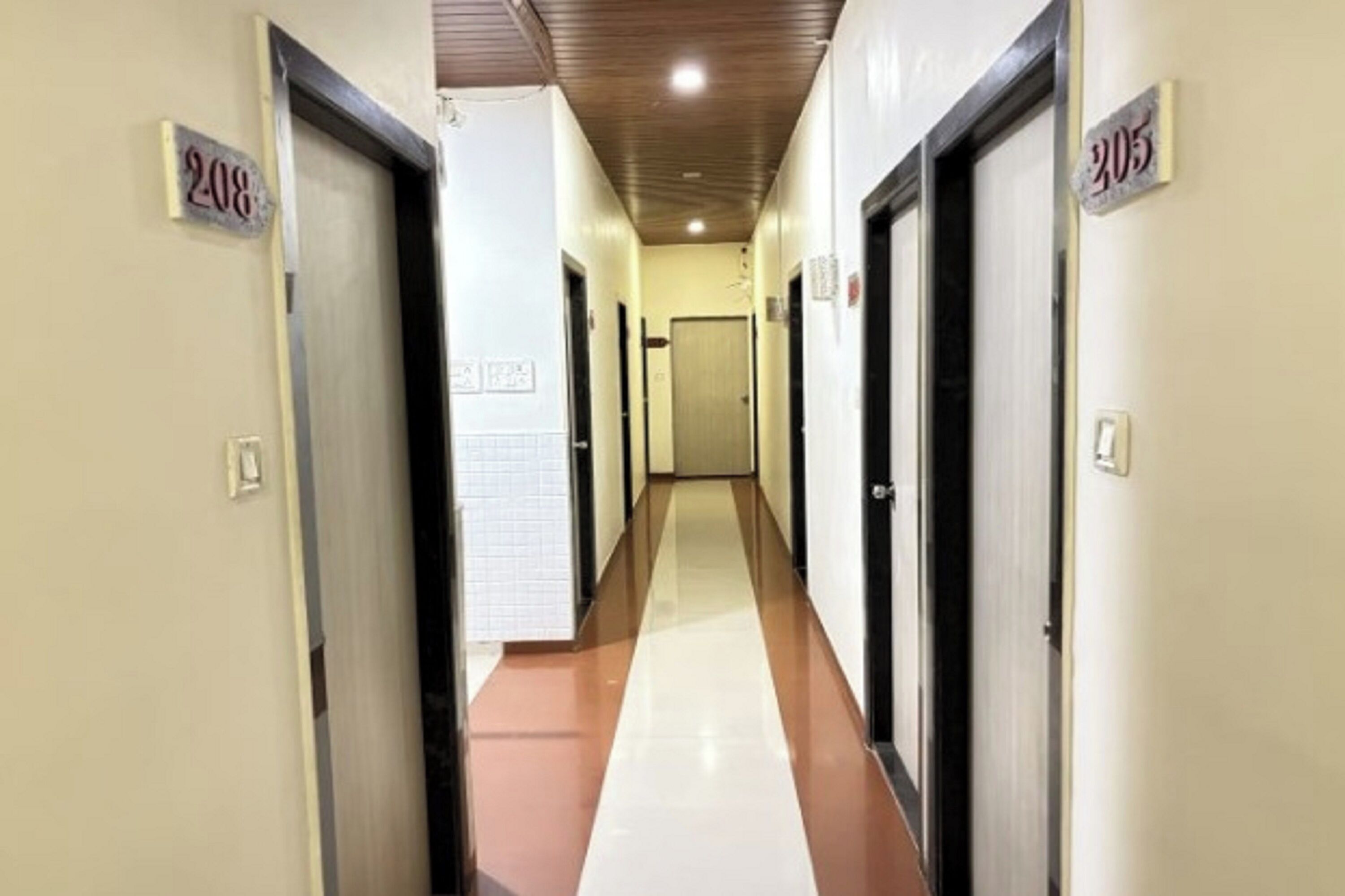A hallway with doors numbered 208 and 305, leading to rooms.
