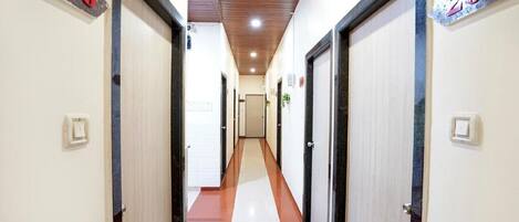 A hallway with doors numbered 208 and 205, leading to rooms.