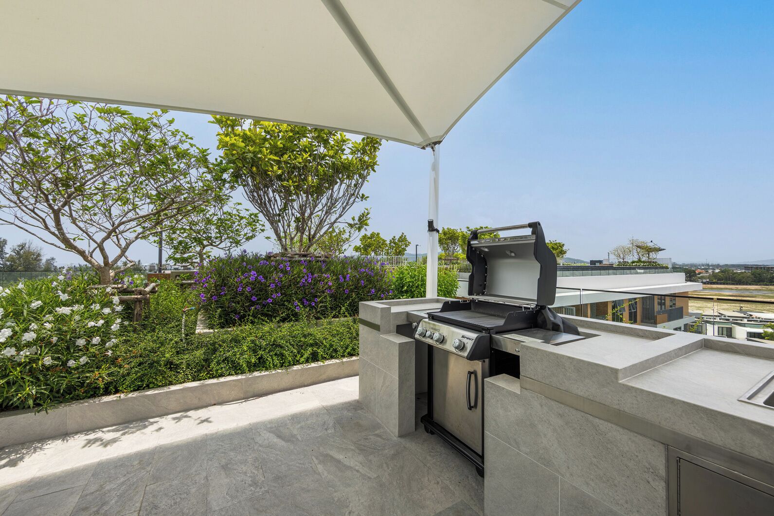An outdoor grill area with a view of the city skyline.