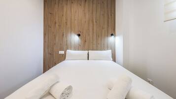 Escritorio, tabla de planchar con plancha, wifi y ropa de cama