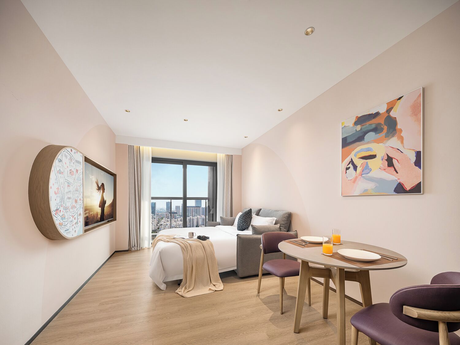 A modern hotel room with a large window, a bed, a dining table, and a painting on the wall.