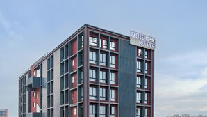 A multi-story building with a prominent sign reading "PRIDE ELITE". - Pride Elite Gandhinagar (Gandhinagar)