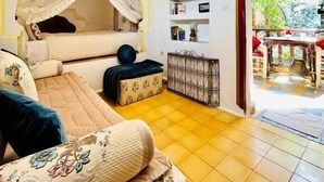 A cozy bedroom with a bed, bedside table, and a view of the outside. - Riad Dar Meziana  (Chefchaouen)