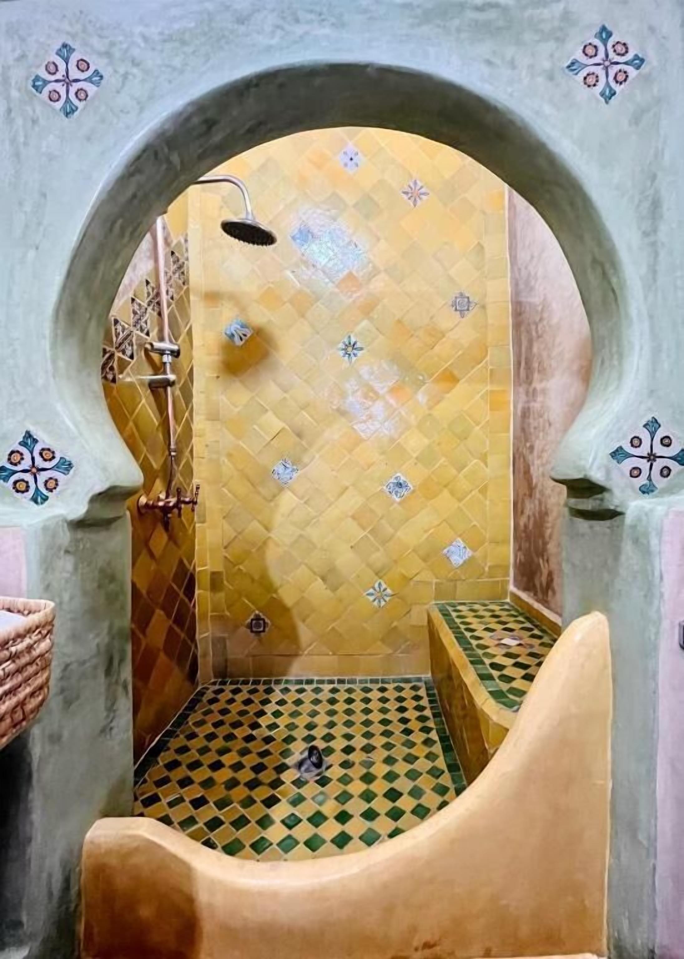 A narrow, tiled bathroom with a checkered floor and a shower area.