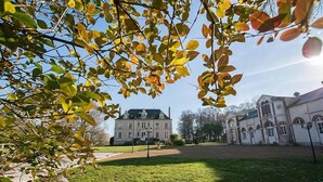 A large building with a symmetrical facade, a central entrance, and a well-maintained lawn in front. - Château de Bel Air (Cérans-Foulletourte)