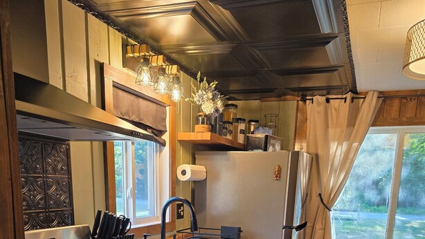 A compact kitchen with a gas stove, sink, and a refrigerator. - Phenomenal 2-bedroom cabin in Saint Helen, the heart of northern Michigan. (St. Helen)