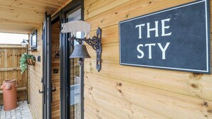 A wooden exterior wall with a sign reading "THE STY". - The Sty (Derby)