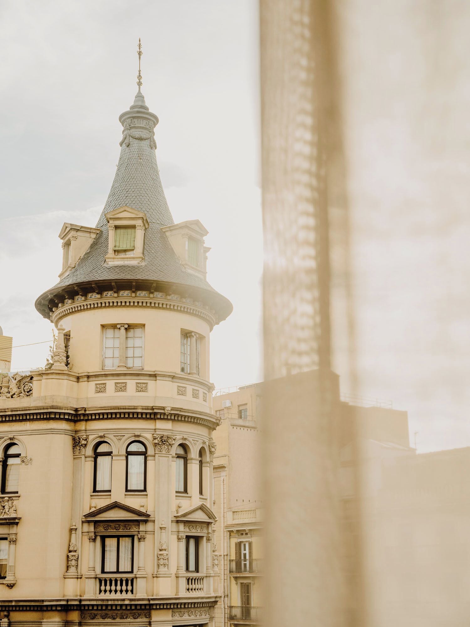 A historic building with a distinctive tower and ornate architectural details.