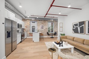 Smart TV - Design-forward flat in Old Town's most iconic building. Exposed brick, bold red ceiling pipes, corner bedroom bathed in natural light. Modern kitchen, quiet side street. Steps from 100+ restaurants & waterfront. A LovableBNB Collection listing. (Alexandria)