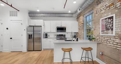 Design-forward flat in Old Town's most iconic building. Exposed brick, bold red ceiling pipes, corner bedroom bathed in natural light. Modern kitchen, quiet side street. Steps from 100+ restaurants & waterfront. A LovableBNB Collection listing.