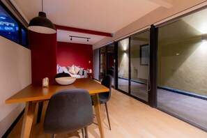 A modern dining area with a wooden table, black chairs, and a large white bowl. - TOP Escaldon Chic 1BR Apartment (Mexico City)