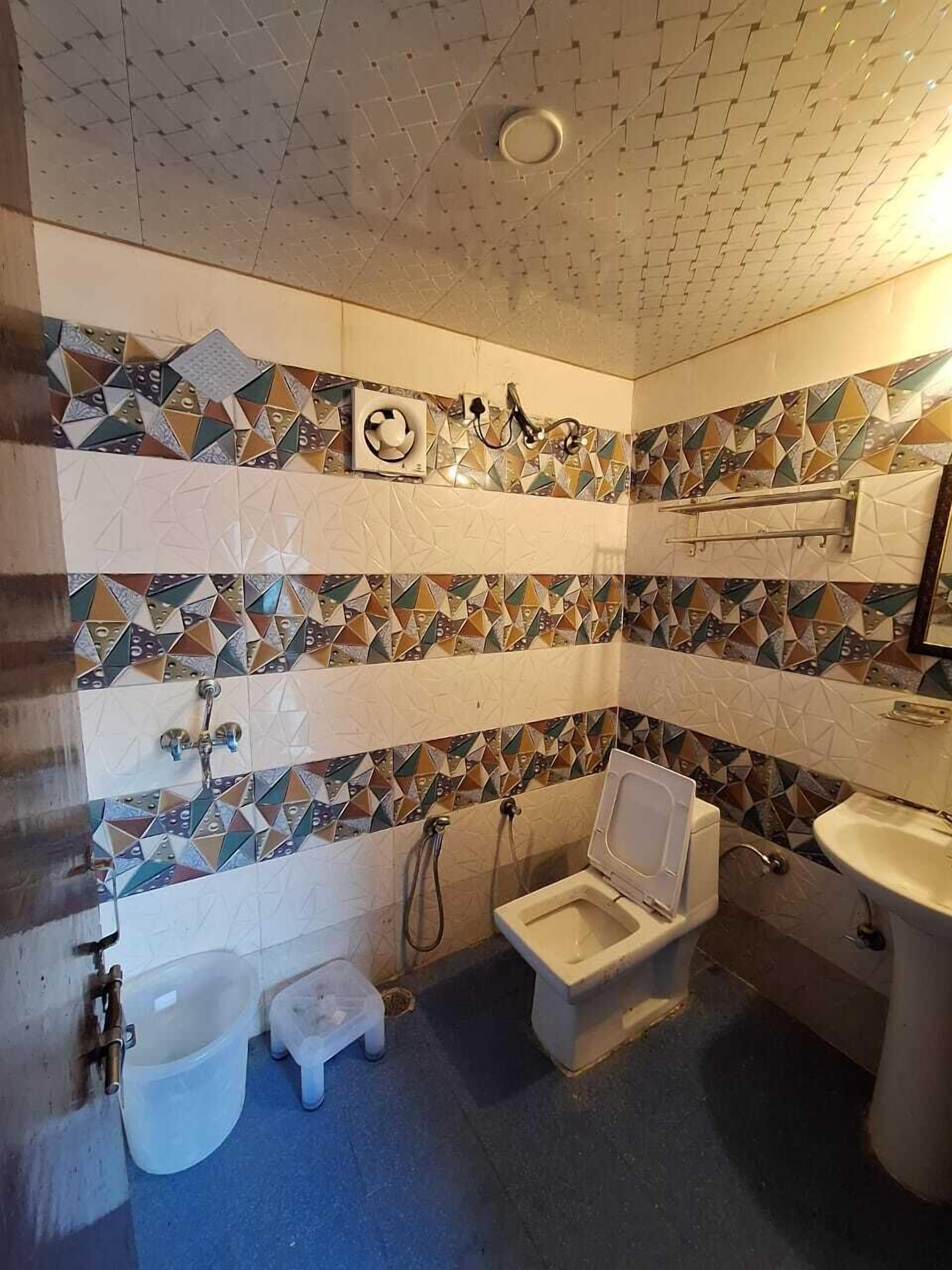 A bathroom with a shower, bidet, and sink.