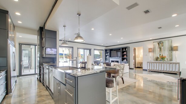 A modern kitchen with a large island, built-in appliances, and ample natural light. - Private Pool & Slip: Luxury Lake Hamilton Home! (Hot Springs)