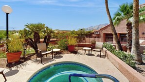 A pool area with chairs and potted plants. - 1 BR Condo in Tucson, Mountain Views (Tucson)