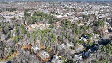 An aerial view of a residential area with houses surrounded by trees.