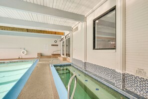A swimming pool with a tiled edge, a handrail, and a window on the right side. - 1 Mi to CU Boulder! Walkable Condo w/ Indoor Pool (Boulder)