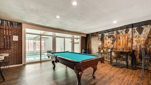 A pool table in a room with wooden flooring, a brick wall, and a mural. - 1 Mi to CU Boulder! Walkable Condo w/ Indoor Pool (Boulder)