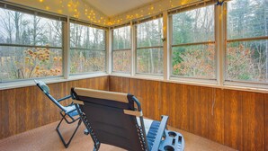 A room with large windows, a skylight, and a massage table.