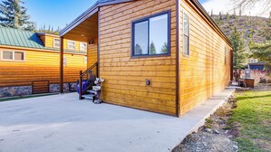 A wooden cabin with a covered porch and a stone wall foundation. - Brand New Scandinavian Cabin 5 Mi to Main St Breck (Breckenridge)