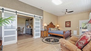 A spacious room with a bed, a sofa, a dining area, and a kitchen in the background. - Alanamari Desert Estate, Pool, Spa, Casita 4 Bedroom Home (Phoenix)