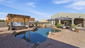 A backyard with a swimming pool, a pergola with a barbecue, and outdoor seating. - Alanamari Desert Estate, Pool, Spa, Casita 4 Bedroom Home (Phoenix)