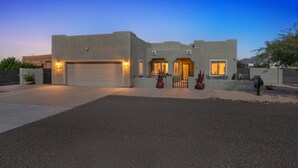 A modern house with a garage, a covered patio, and a well-maintained driveway. - Alanamari Desert Estate, Pool, Spa, Casita 4 Bedroom Home (Phoenix)