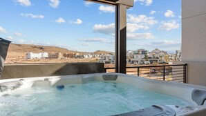 A hot tub with a clear view of a residential area in the background. - The Fish Bowl 6 Bedroom Townhouse (St. George)
