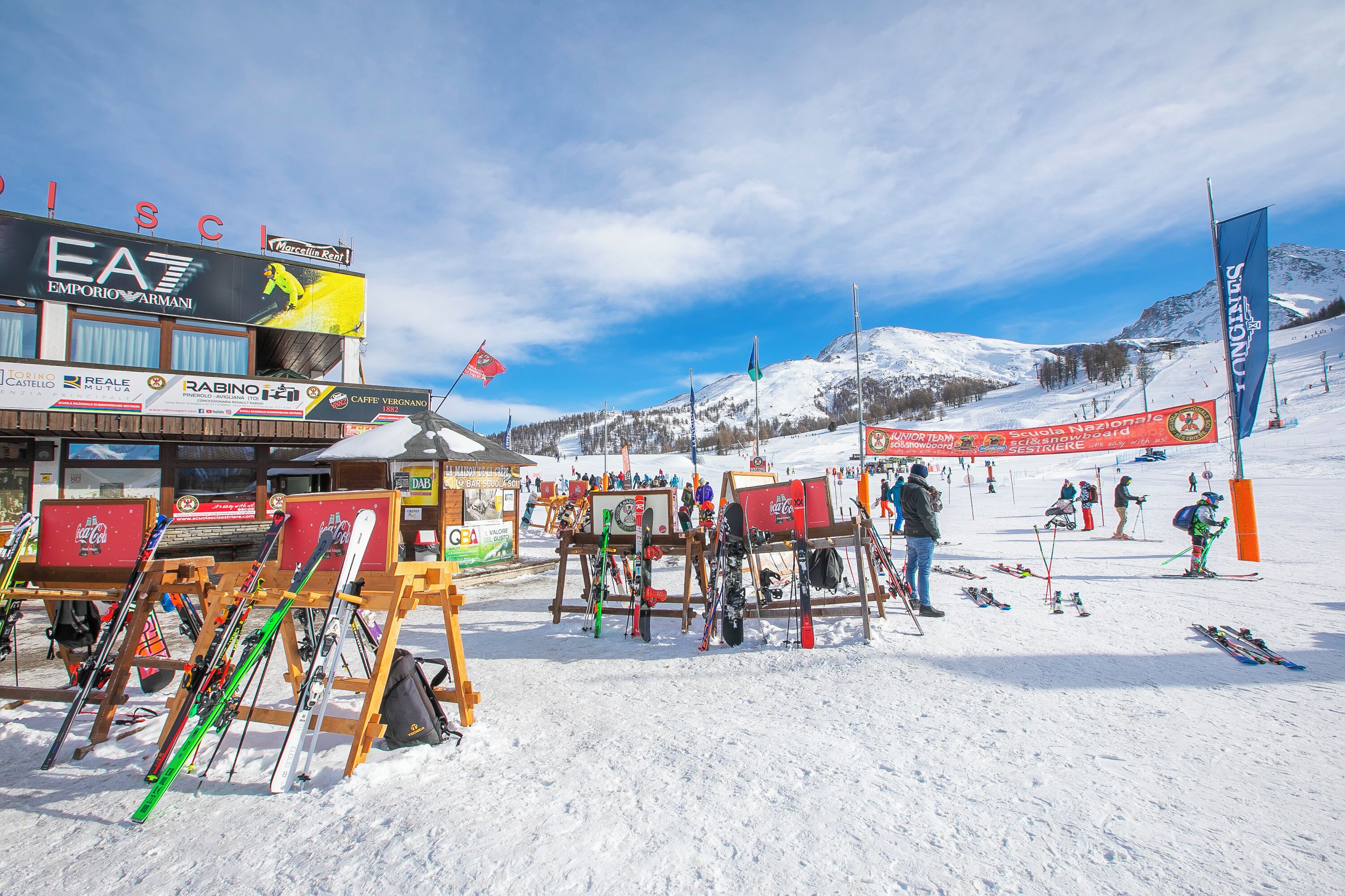 A ski resort with ski equipment and a sign for Emporio Armani.