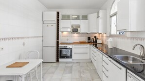 A modern kitchen with white cabinetry, a built-in microwave, a coffee maker, and a sink. - Private Villa with Sea Views in Torreblanca, Fuengirola (Fuengirola)