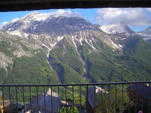 A mountain landscape with a valley and a building in the foreground. - Mountain Vacation Rentals   (Orcières)